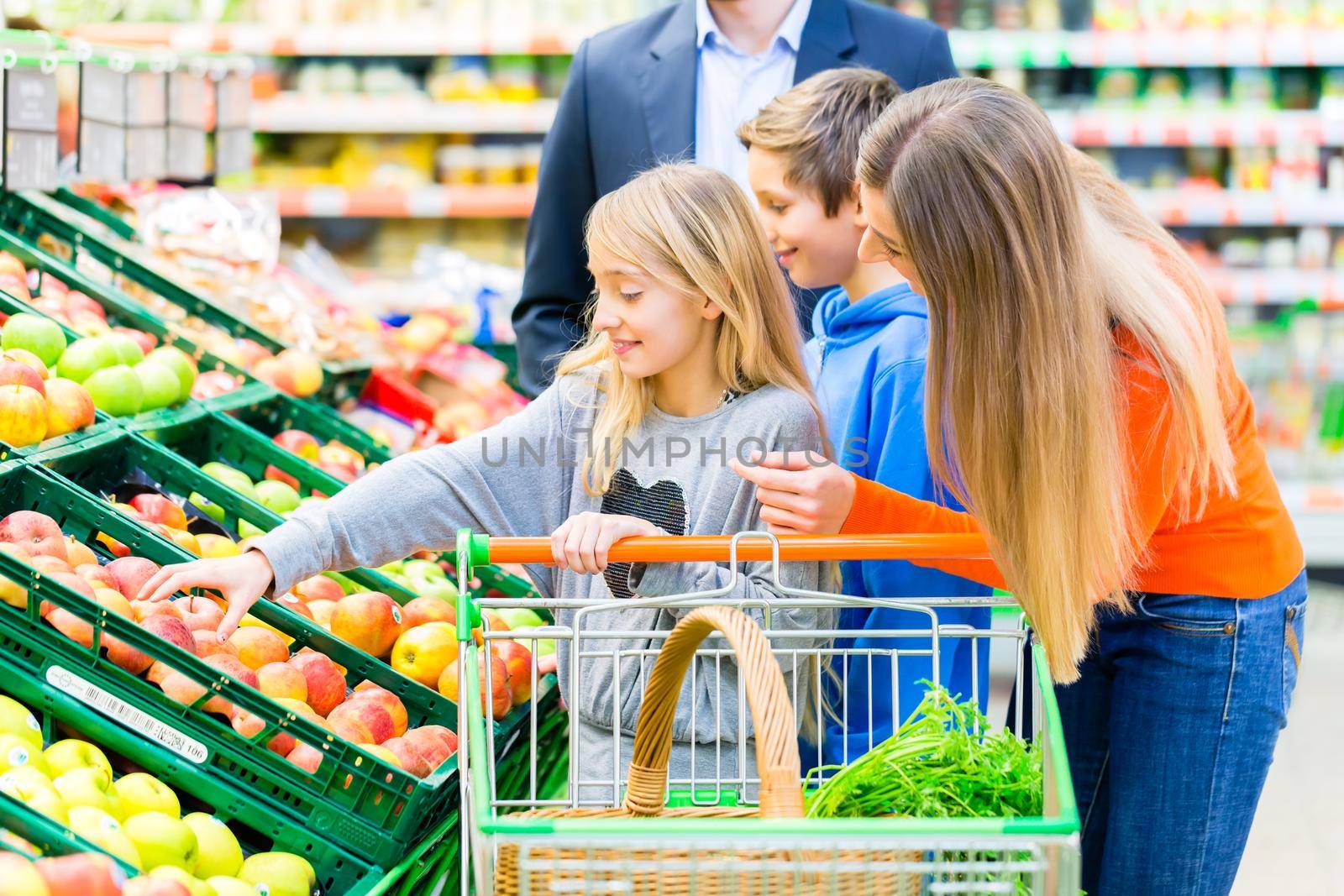 Family grocery shopping in hypermarket by Kzenon