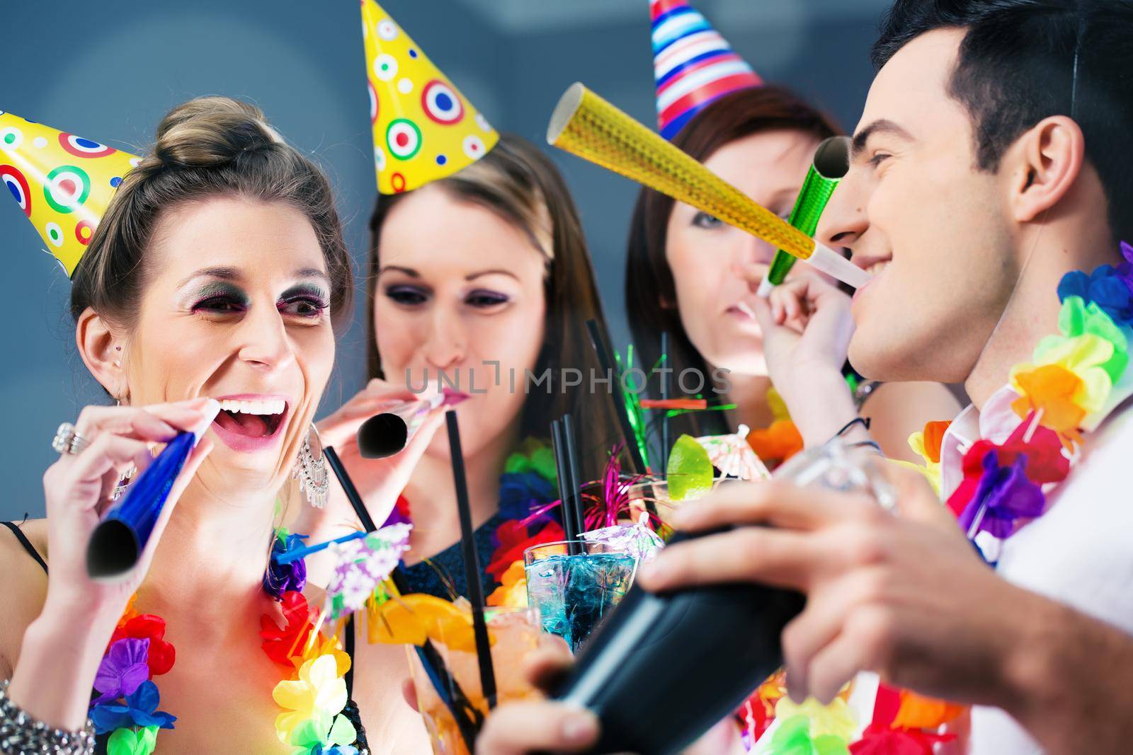 Party People in bar celebrating carnival, group having fun with drinks and a barkeeper