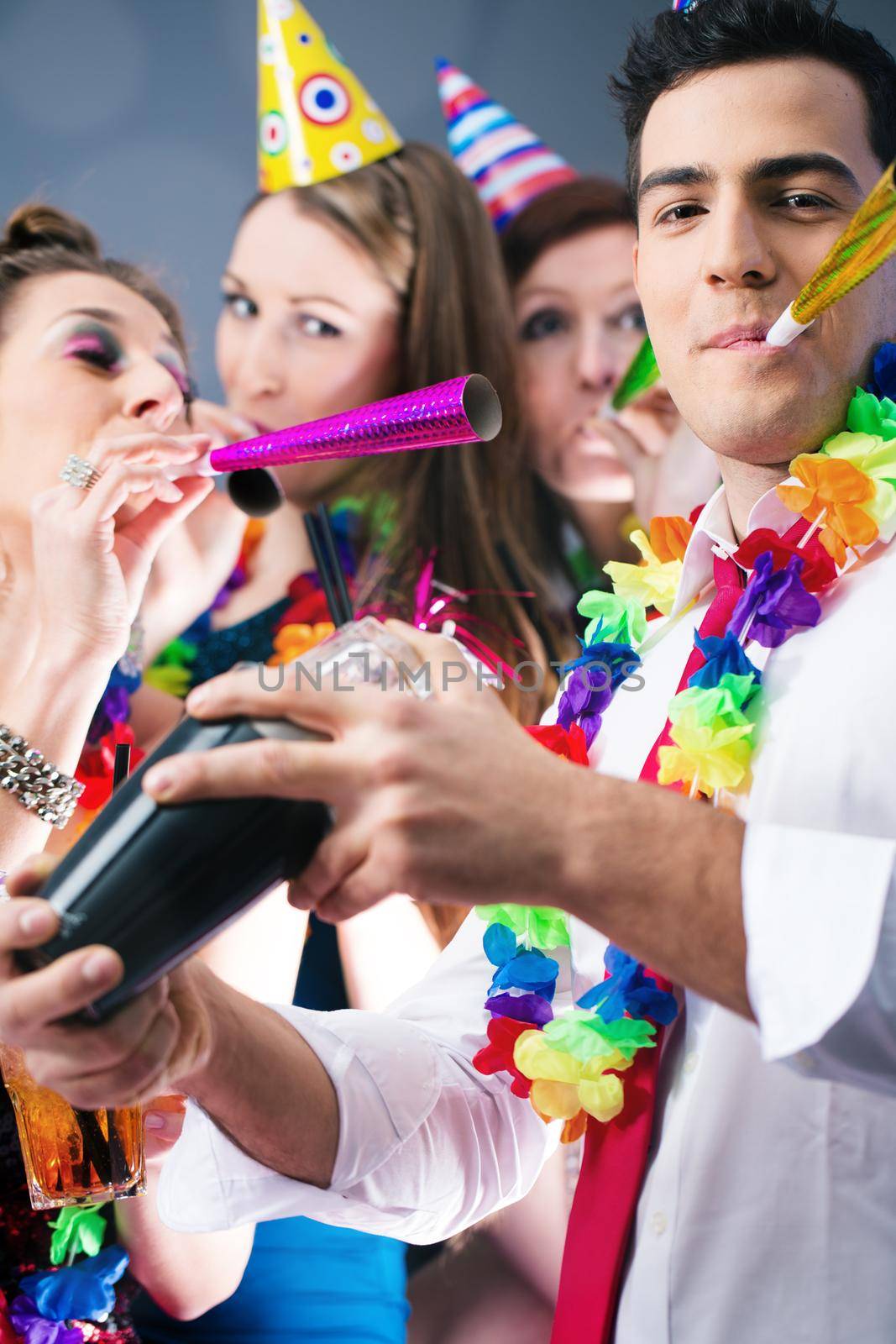 Party People in bar celebrating carnival, group having fun with drinks and a barkeeper