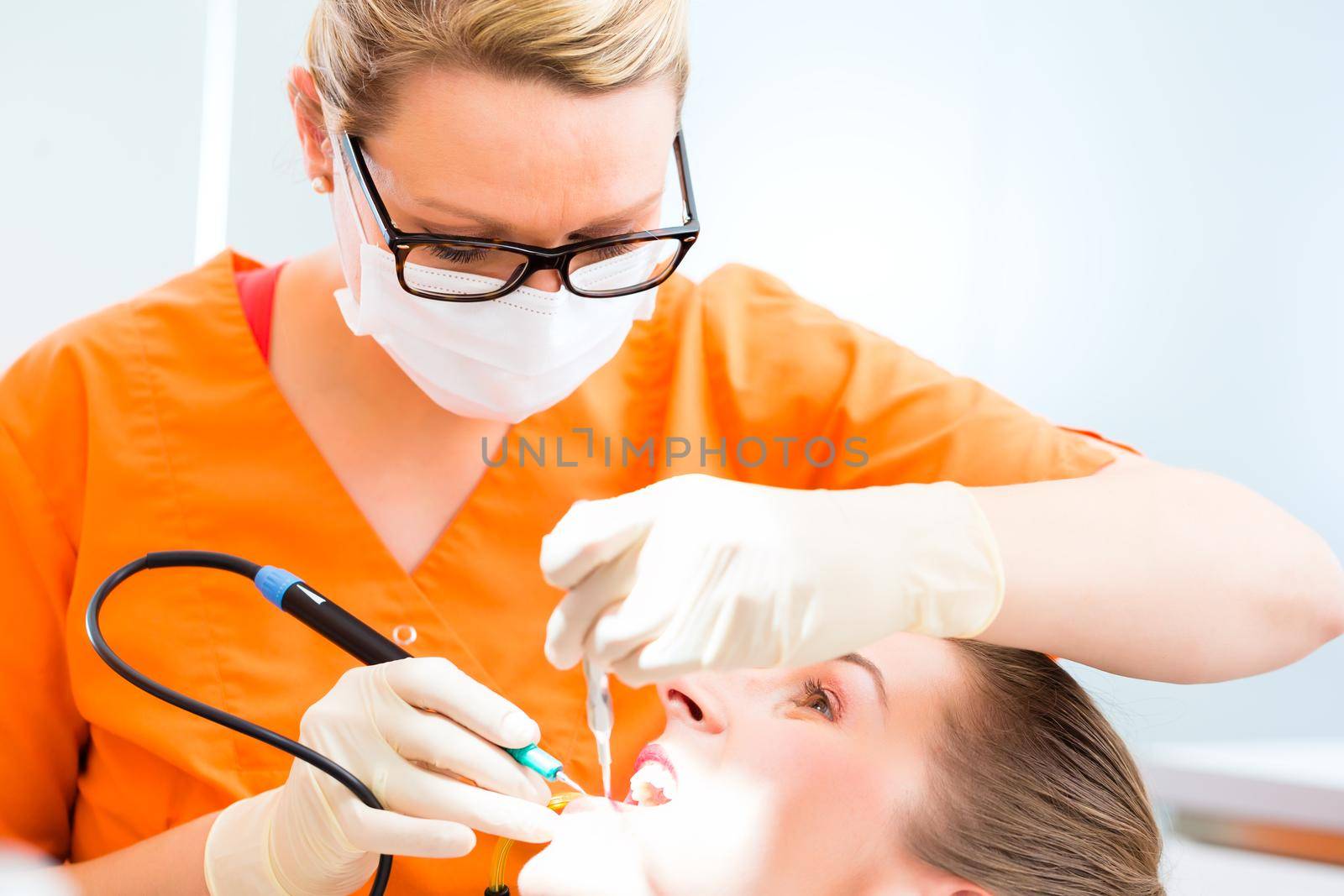 Patient having dental tooth cleaning at dentist