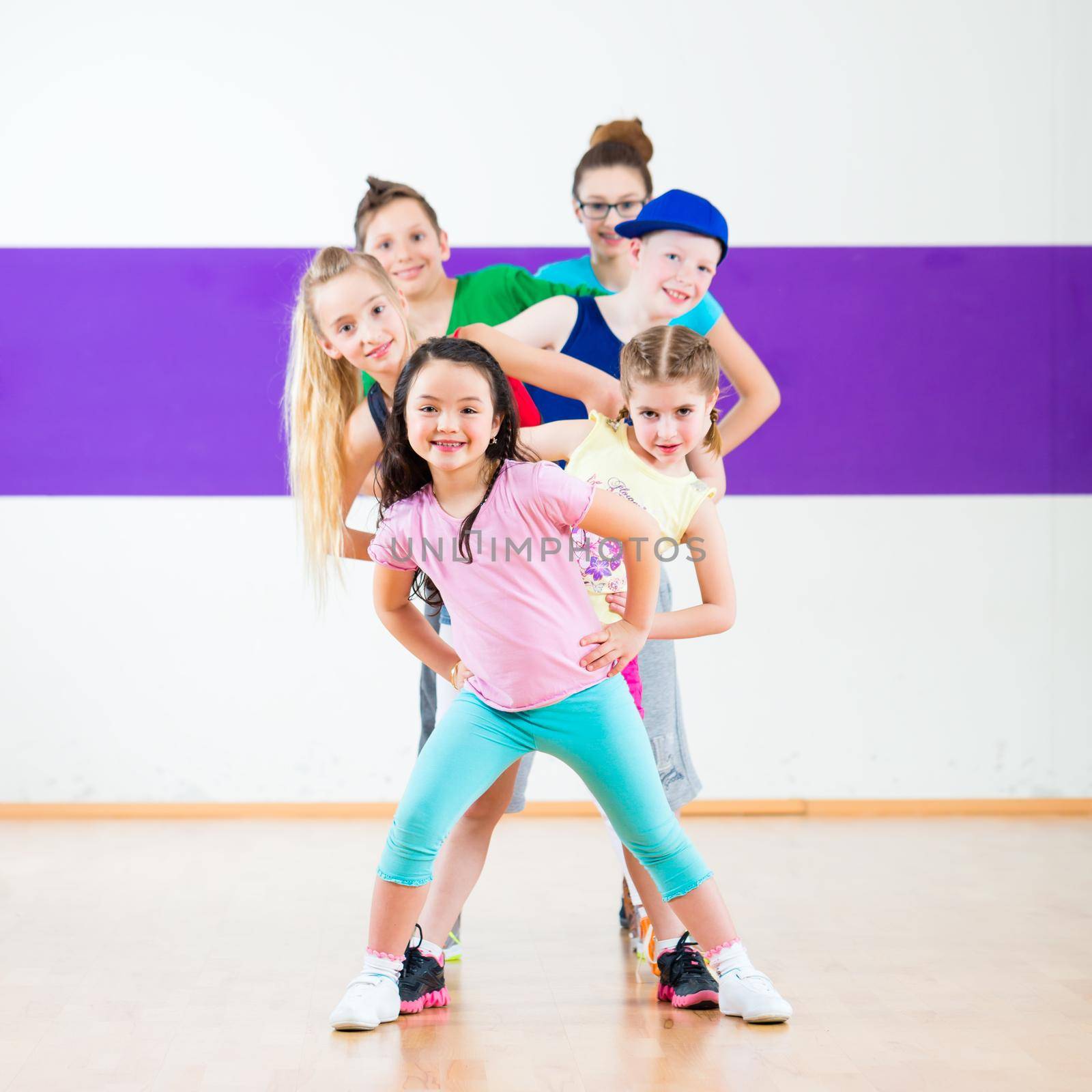 Kids train Zumba fitness in dancing school by Kzenon