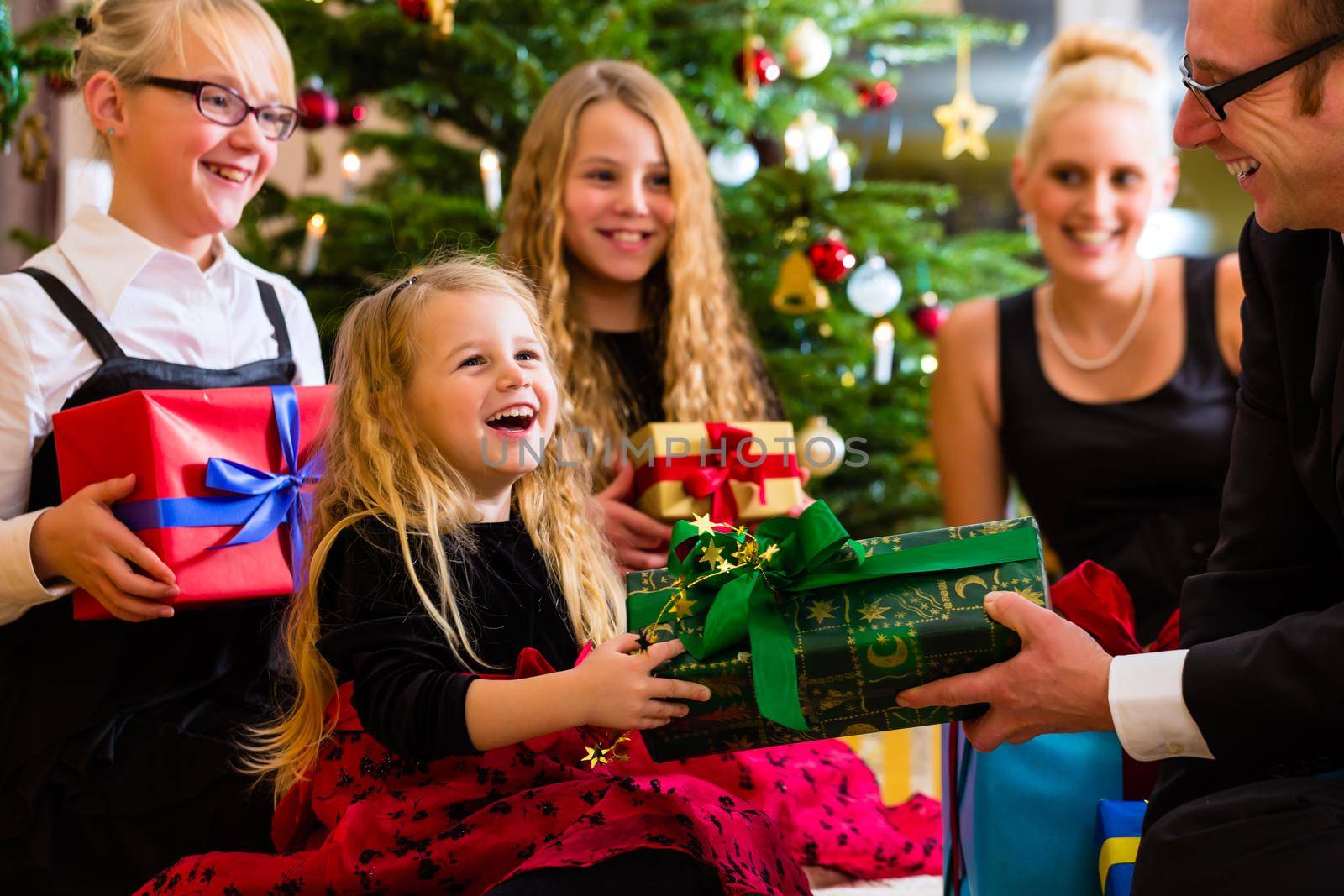 Parents and children with presents on Christmas day