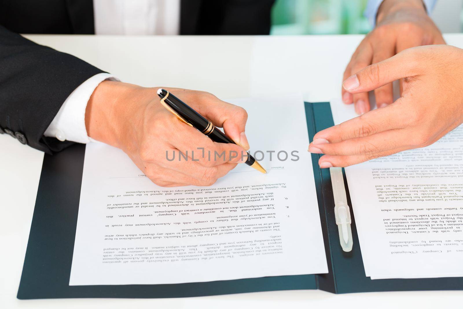 Business people signing agreement in office