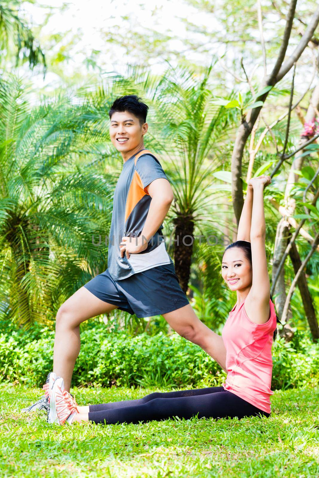 Asian Chinese couple at outdoor fitness training by Kzenon