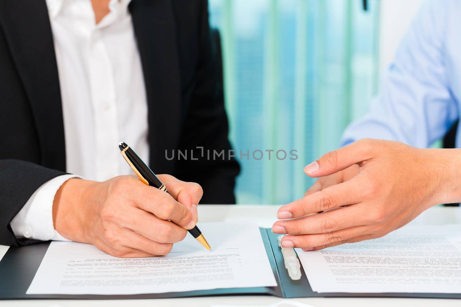 business people signing agreement in office