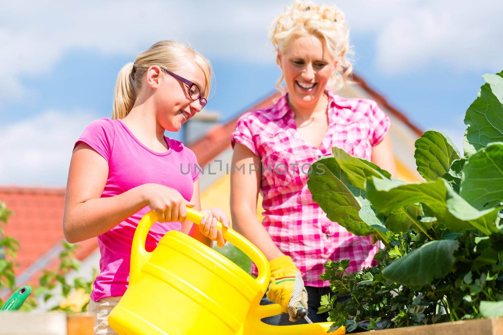 Family gardening in front of their home by Kzenon