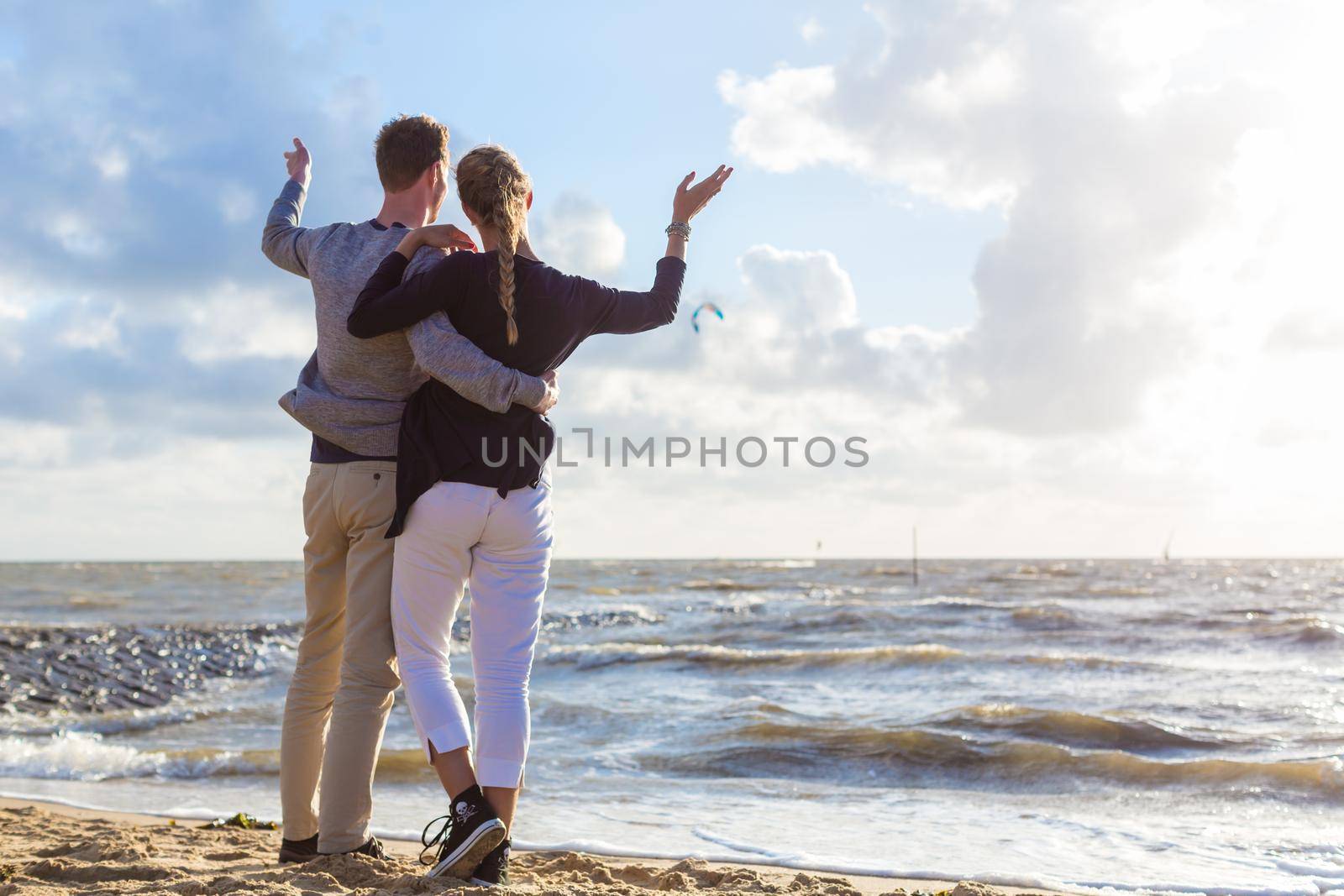 Couple enjoying romantic sunset at German north sea beach