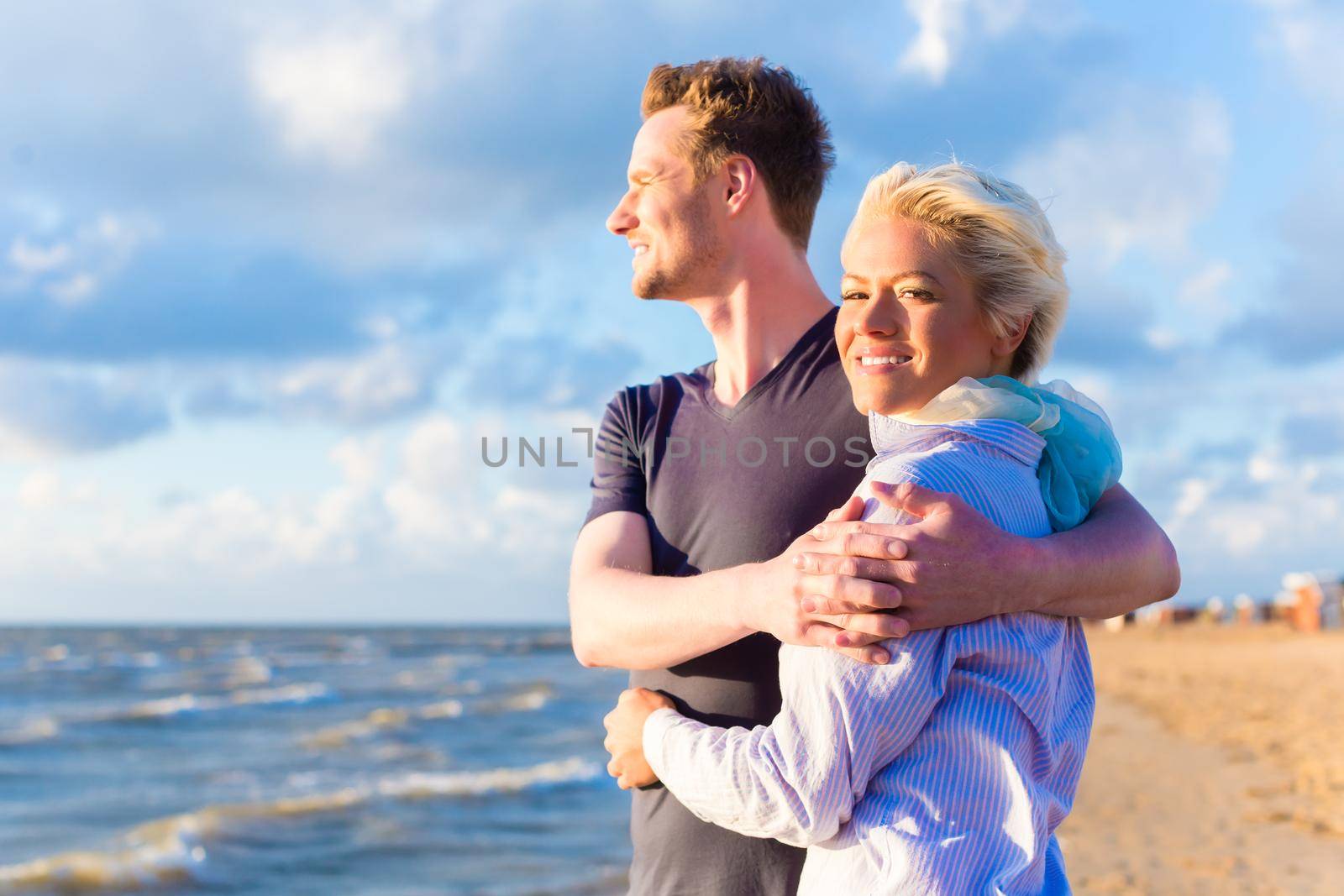 Couple enjoying romantic sunset at German north sea beach