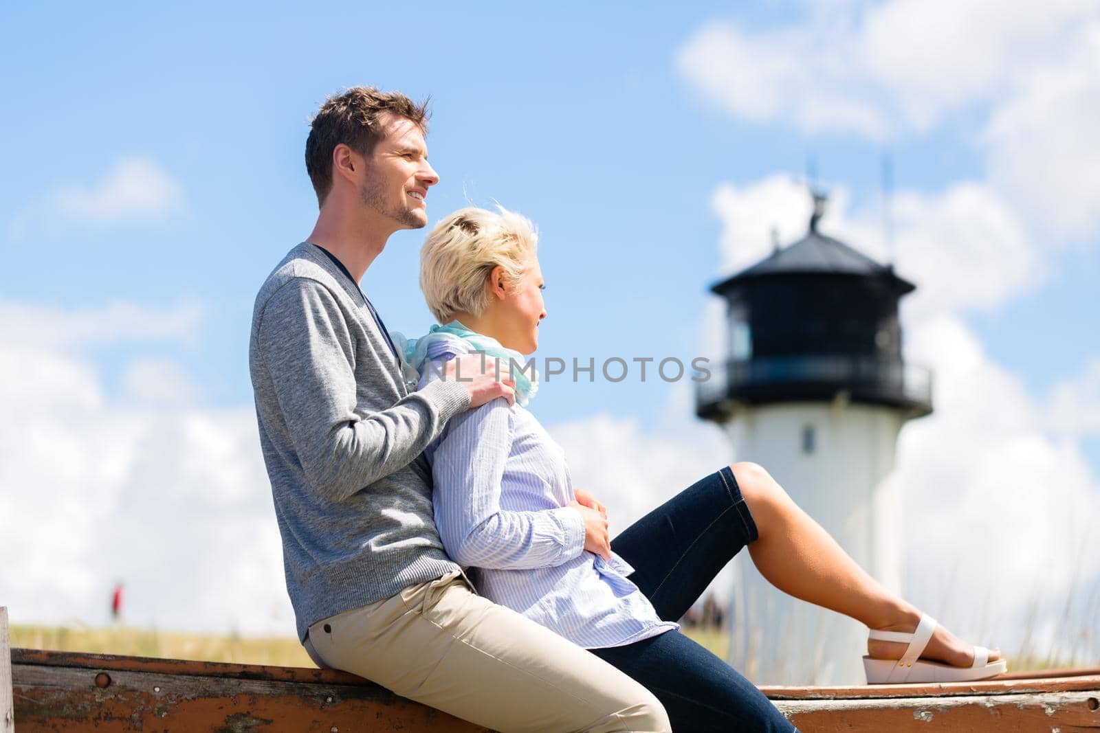 Couple enjoying holiday in beach dune by Kzenon