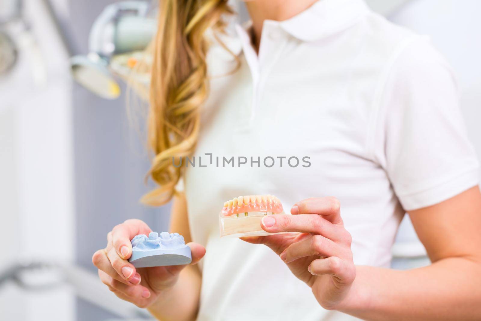 Dental technician checking denture