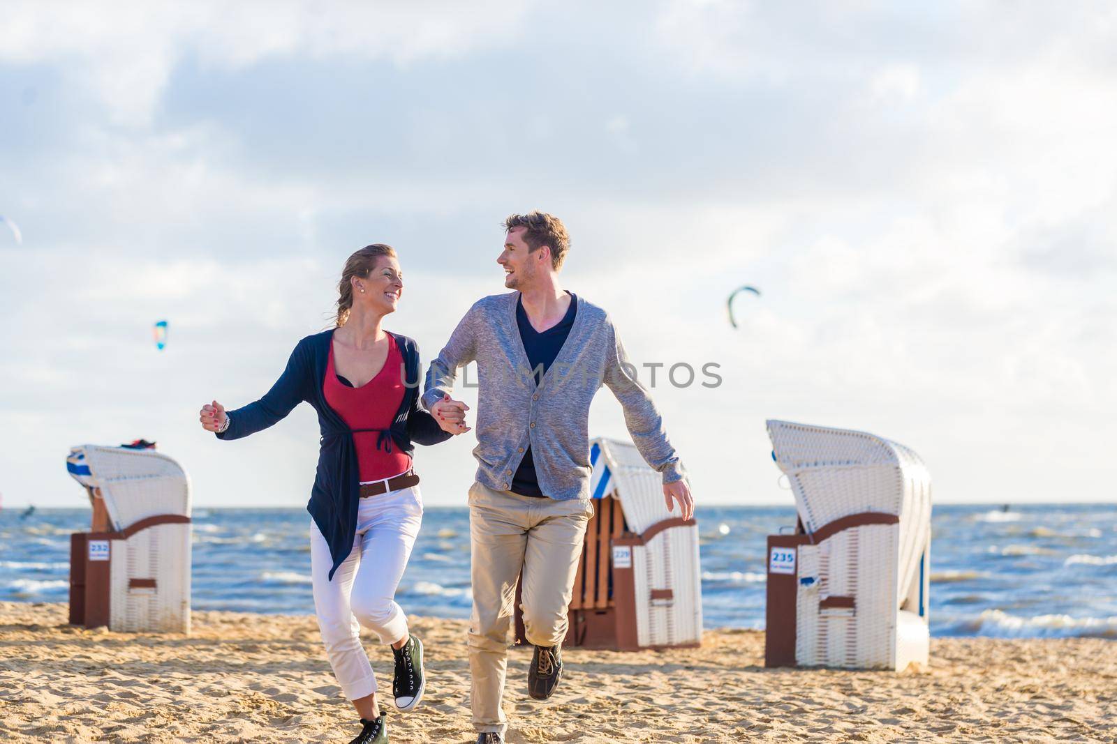 Couple at romantic sunset on beach by Kzenon