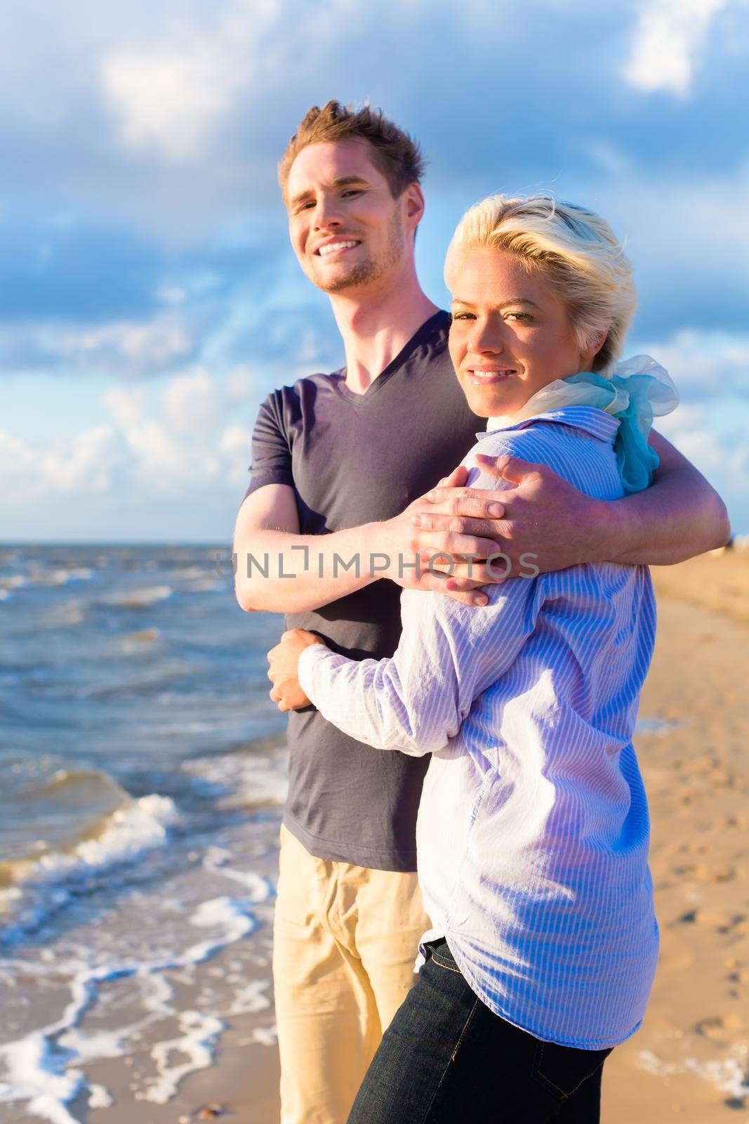 Couple enjoying romantic sunset at German north sea beach