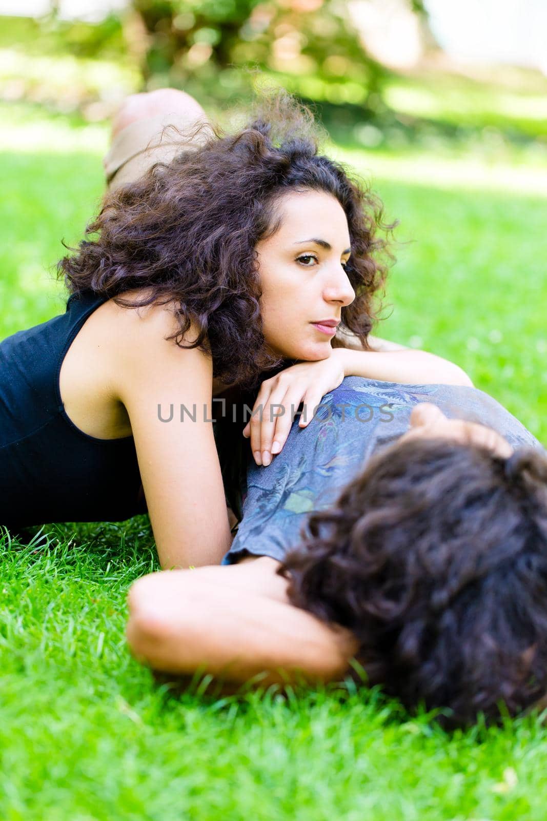 Couple, Latin man and woman, girlfriend and boyfriend, on meadow sleeping in summer