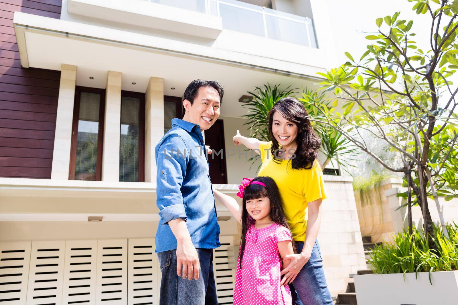 Chinese Family in front of house in residential area in Asia