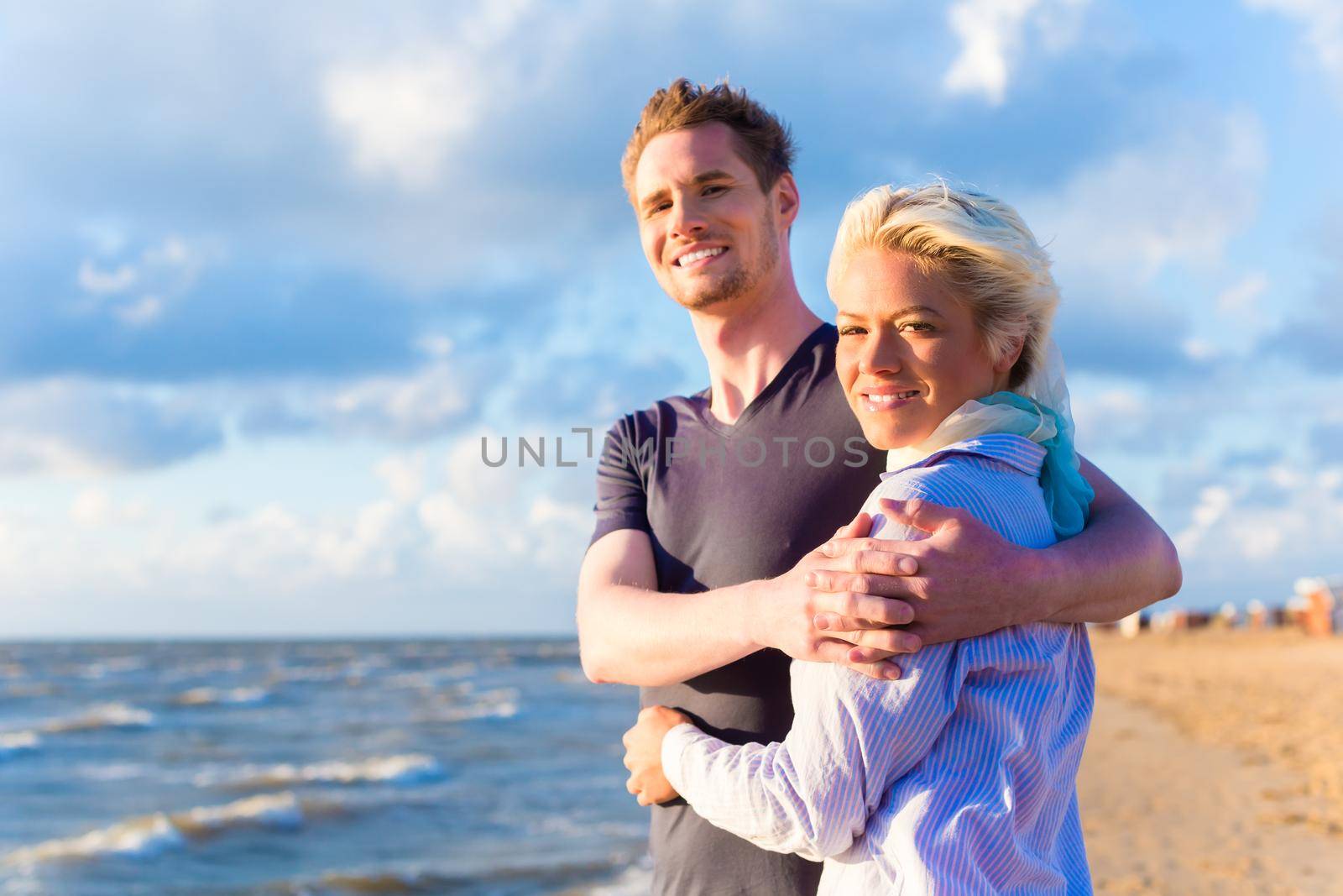 Couple enjoying romantic sunset at German north sea beach