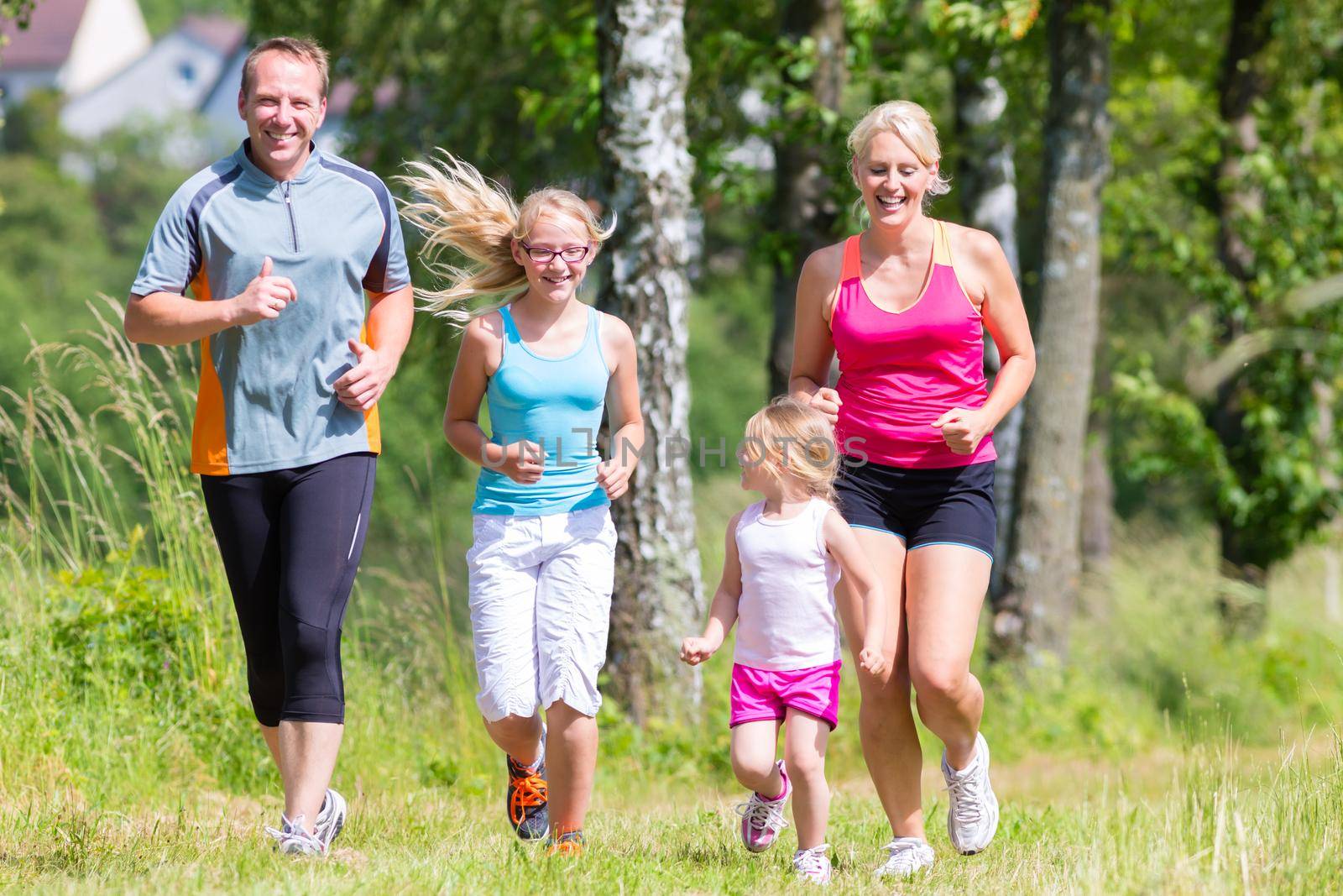 Family sport jogging through field by Kzenon
