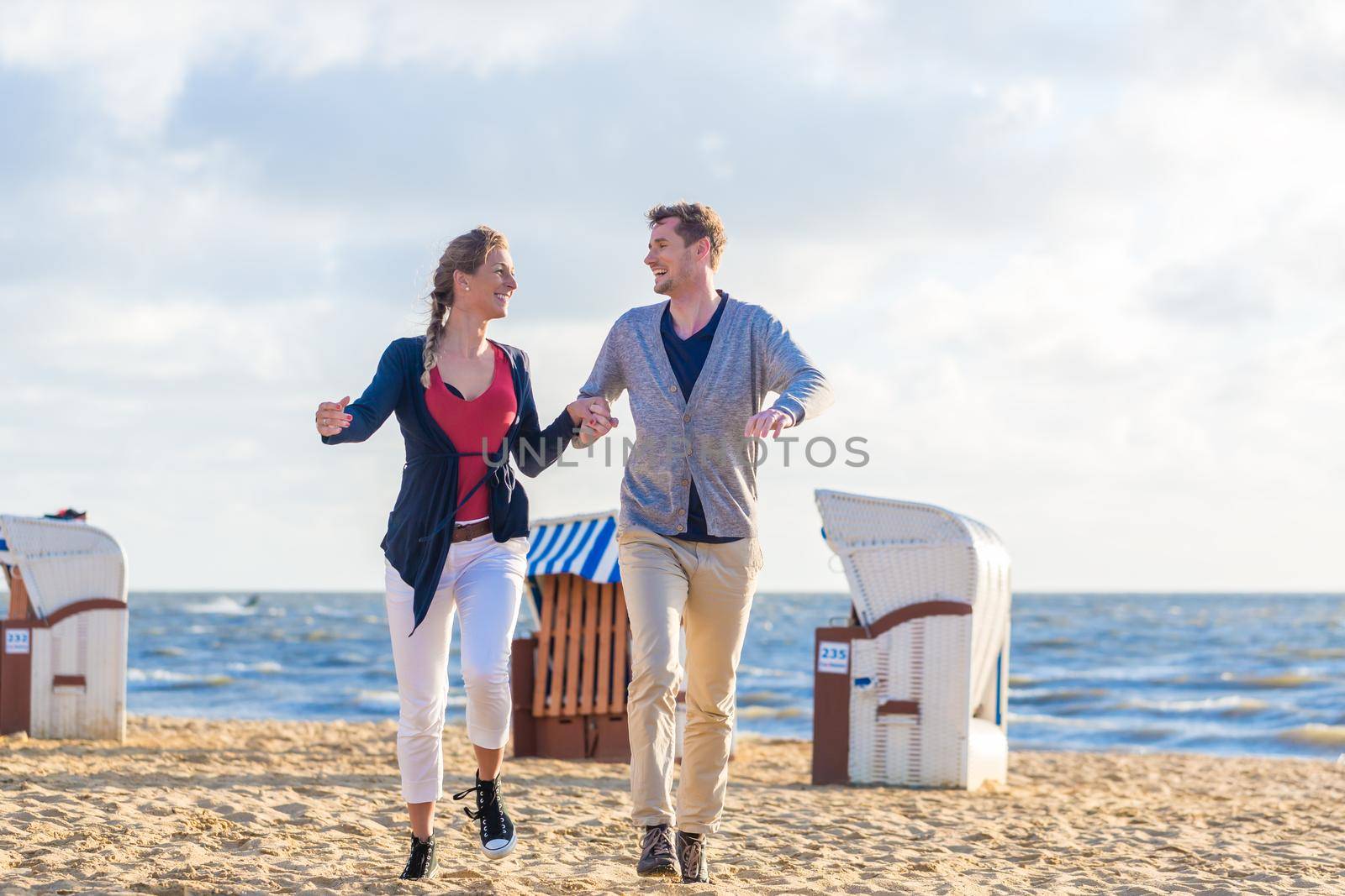 Couple enjoying romantic sunset at German north sea beach