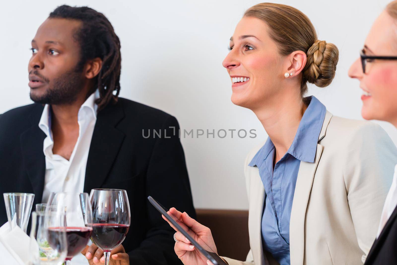 Team of business people having lunch by Kzenon