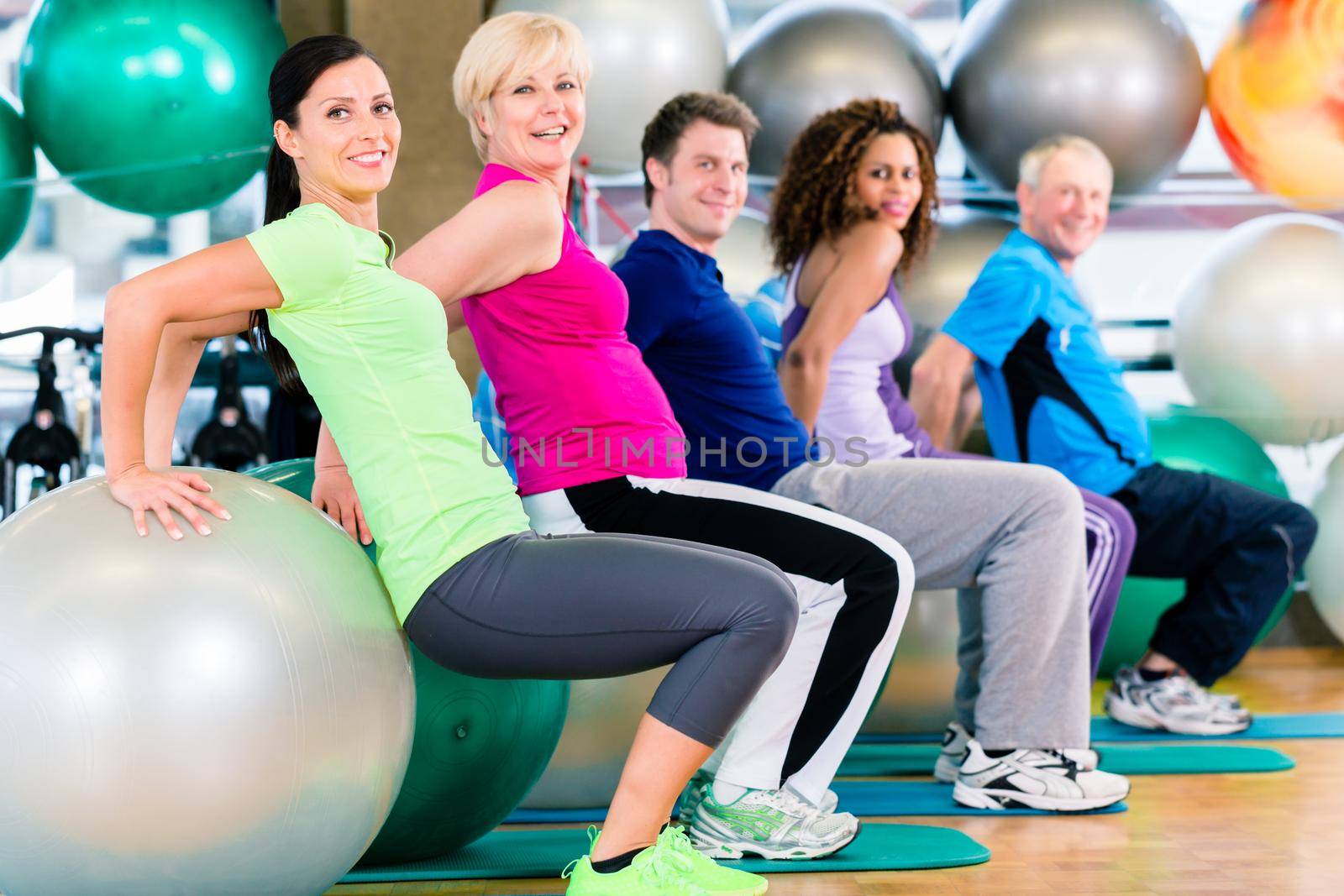 Group of young and senior people exercising in gym, diversity group of and white people