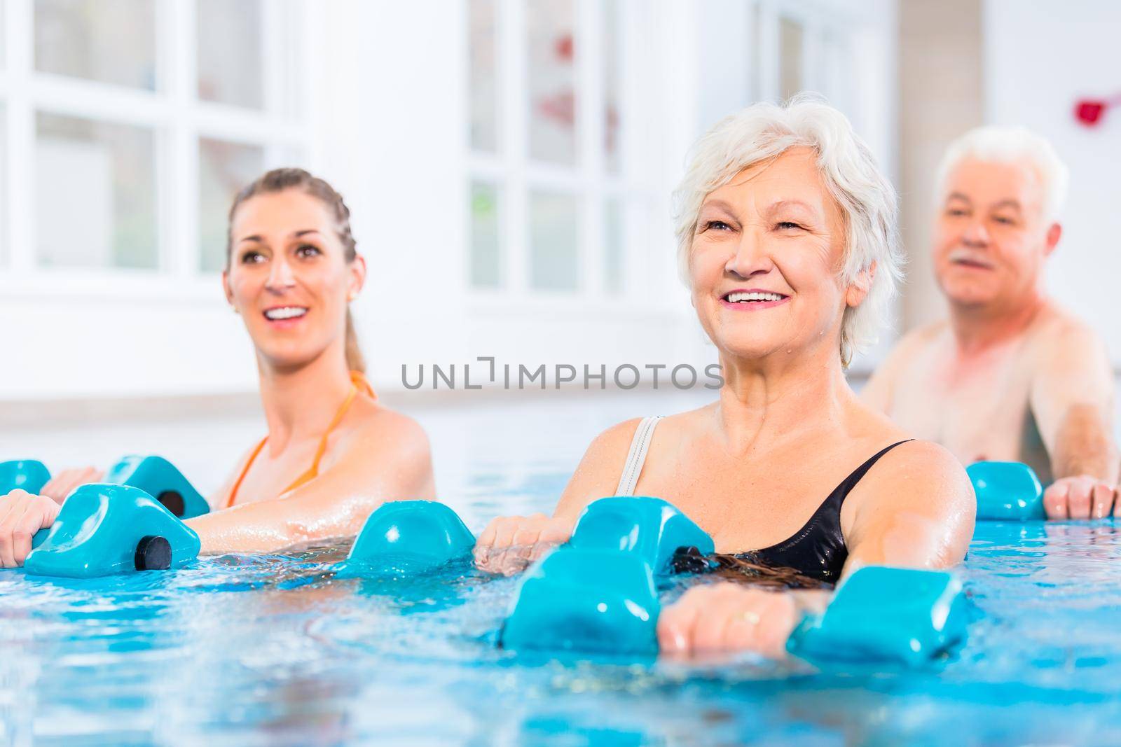 People at water gymnastics in physiotherapy by Kzenon