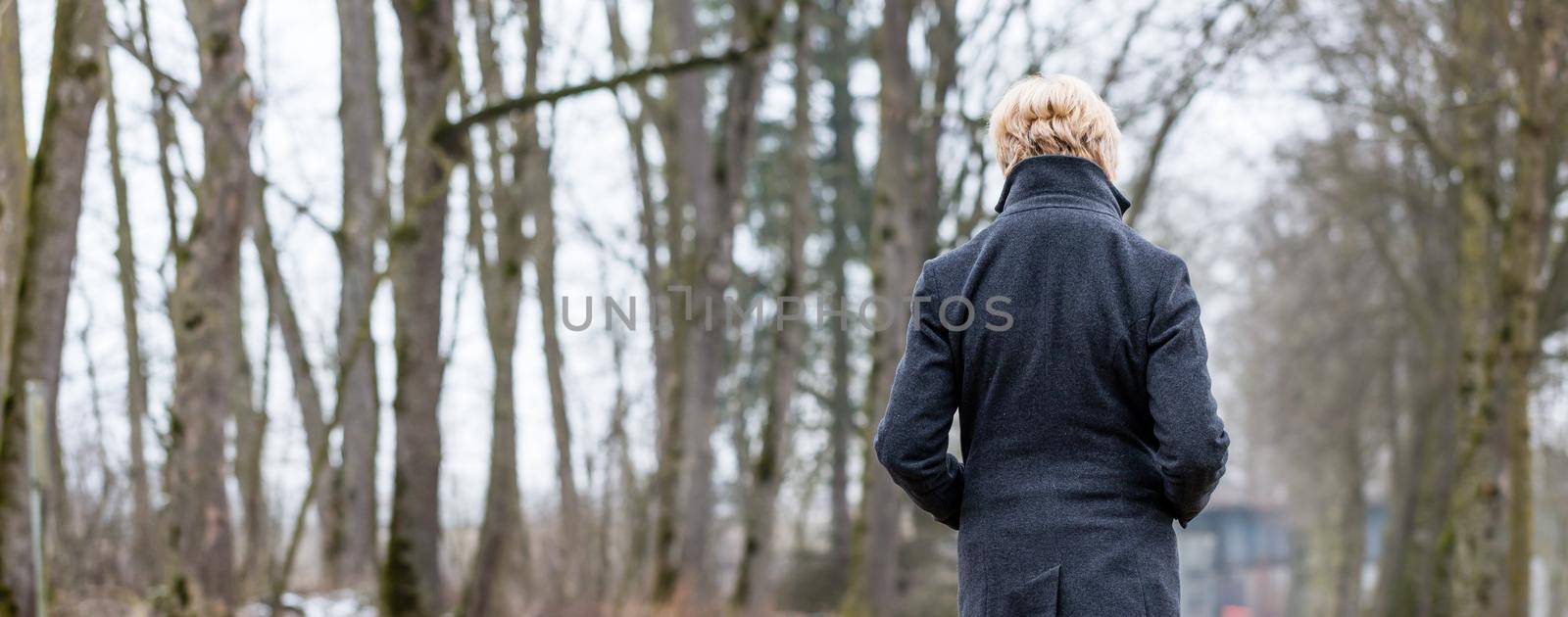 Unhappy woman having walk in winter park