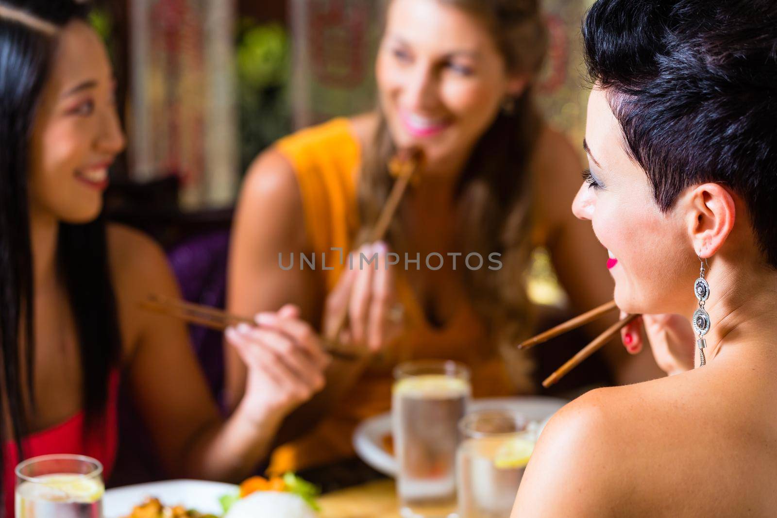 Young people eating in Asia restaurant