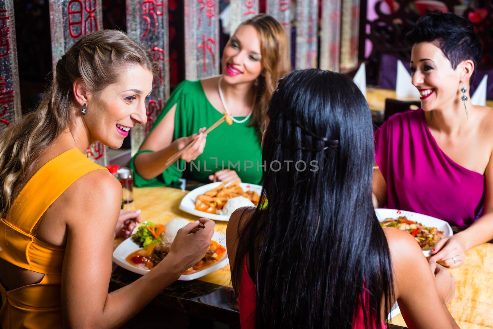 Young people eating in Asia restaurant