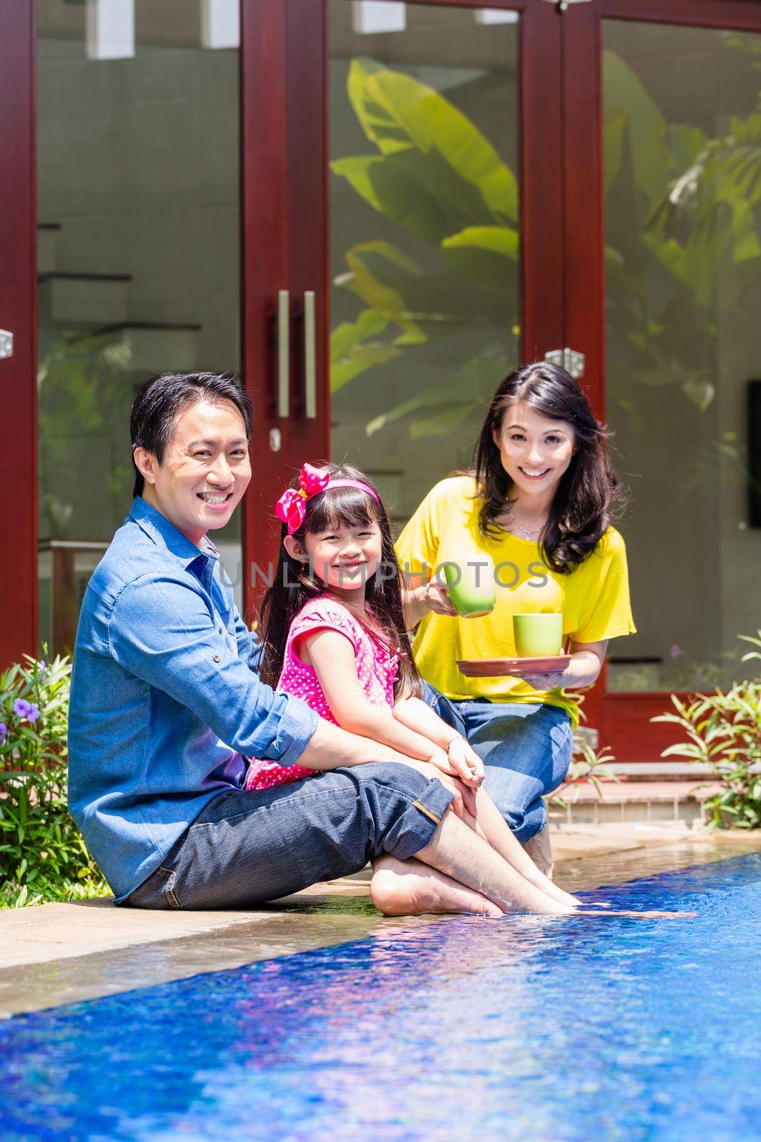 Chinese Family at pool in front of home or house drinking coffee