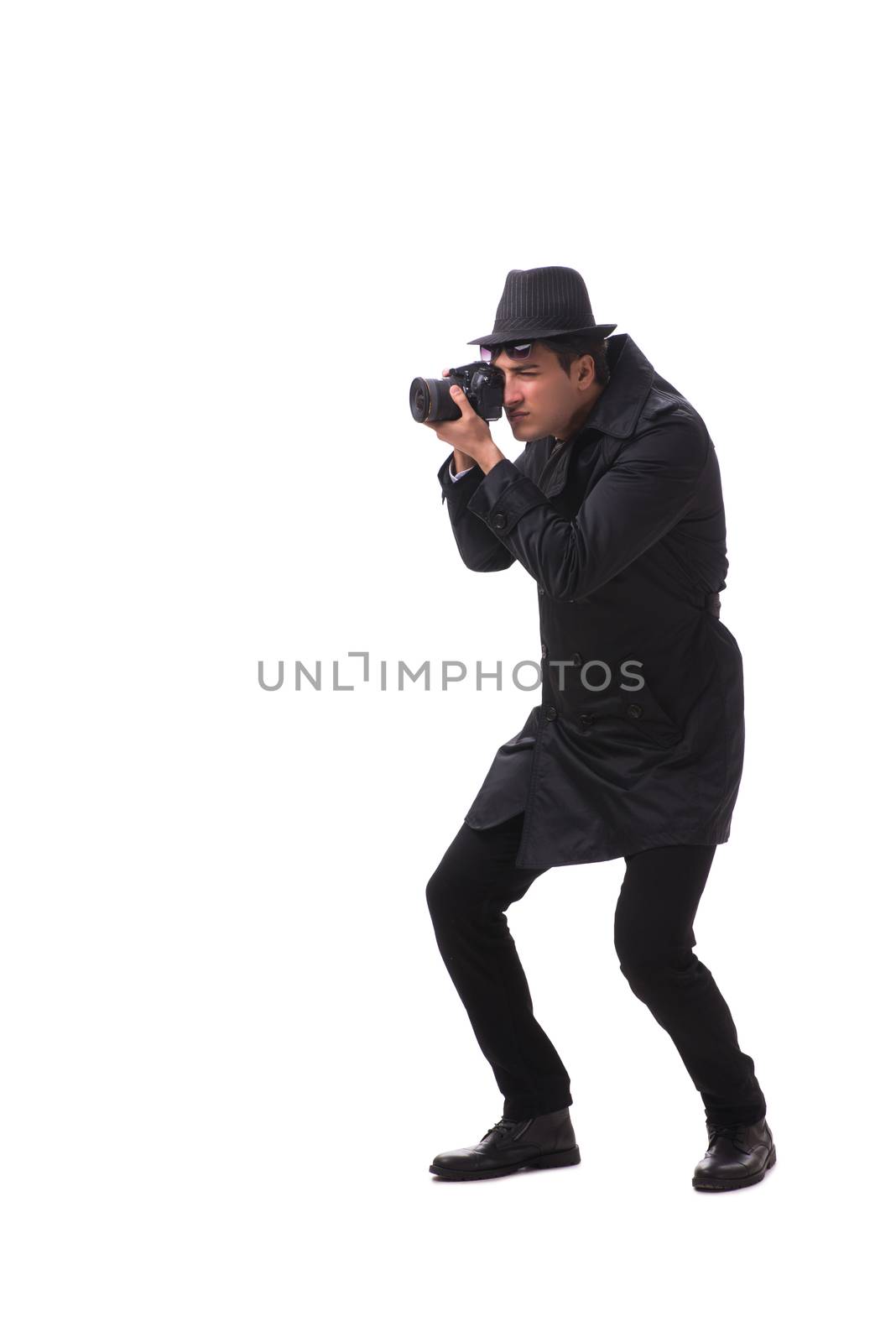 Spy with camera taking pictures isolated on white