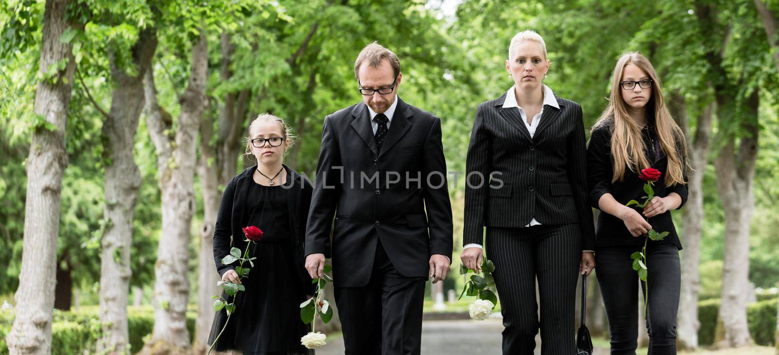 Family walking down alley at graveyard by Kzenon