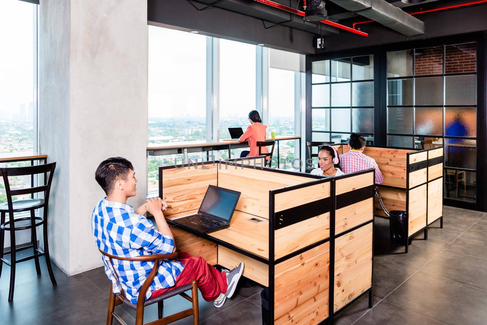 Start-up business people in coworking office working in cubicles