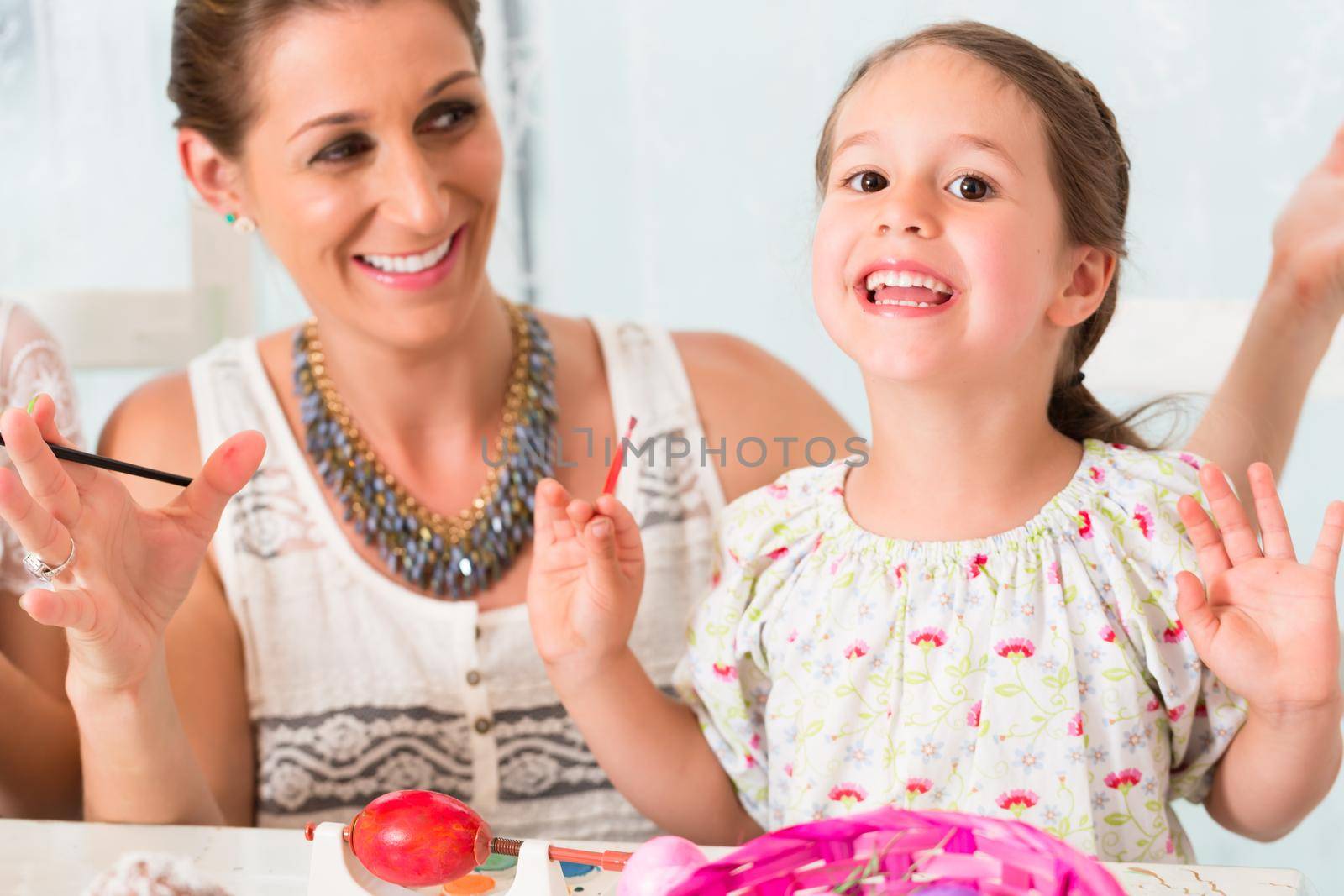 Family having fun coloring Easter eggs