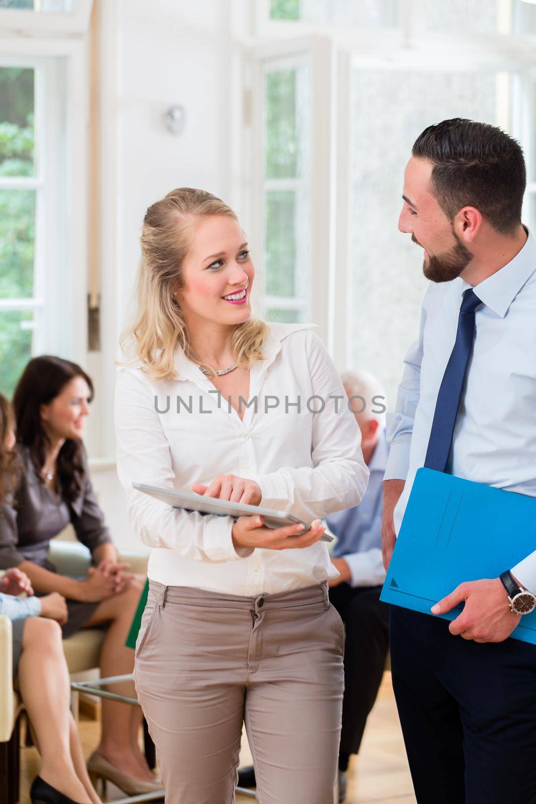 Business people in office having informal meeting and short presentation