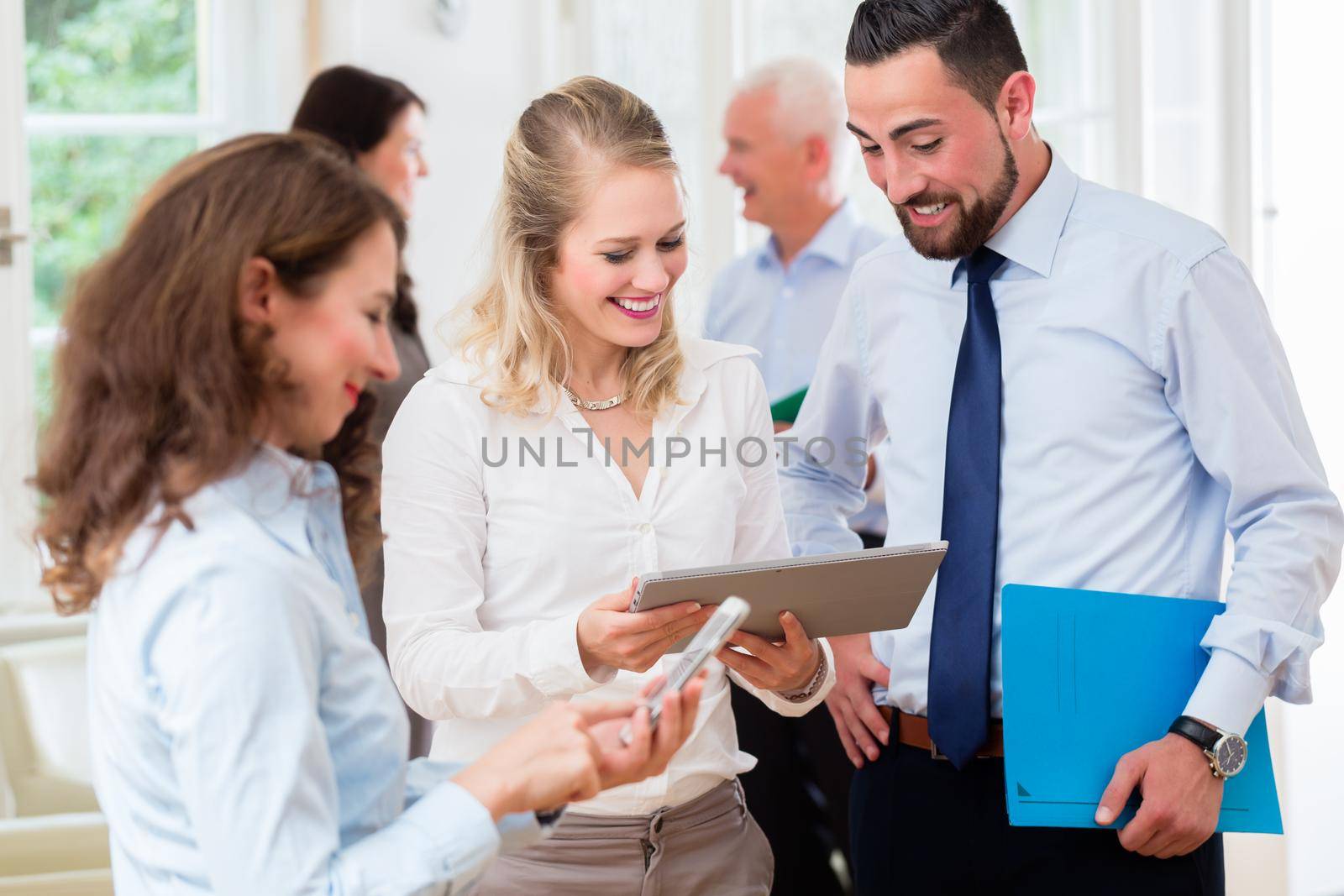 Business people in office having informal meeting and short presentation