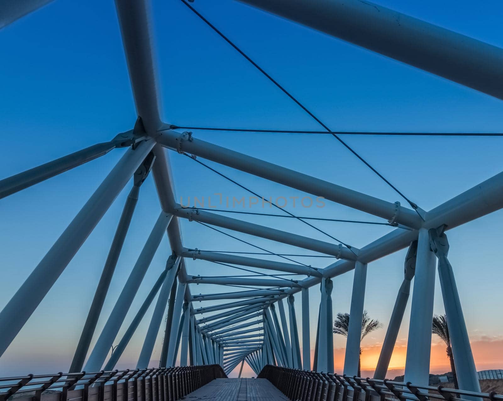Blue cable stayed bridge closeup, upward view, Abstract bridge architecture by isaiphoto