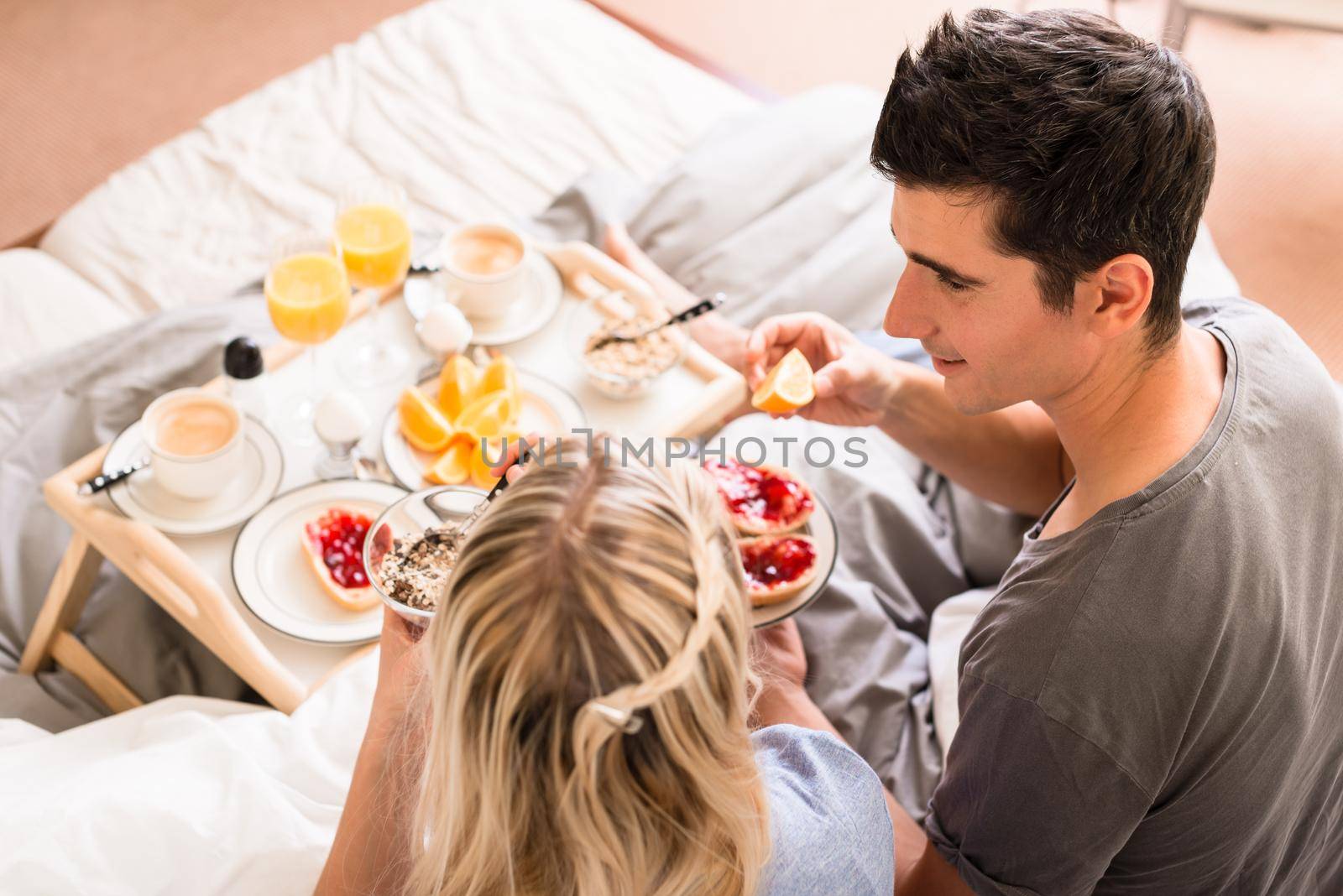 Close-up of romantic healthy breakfast with orange juice, jam, cereals and coffee