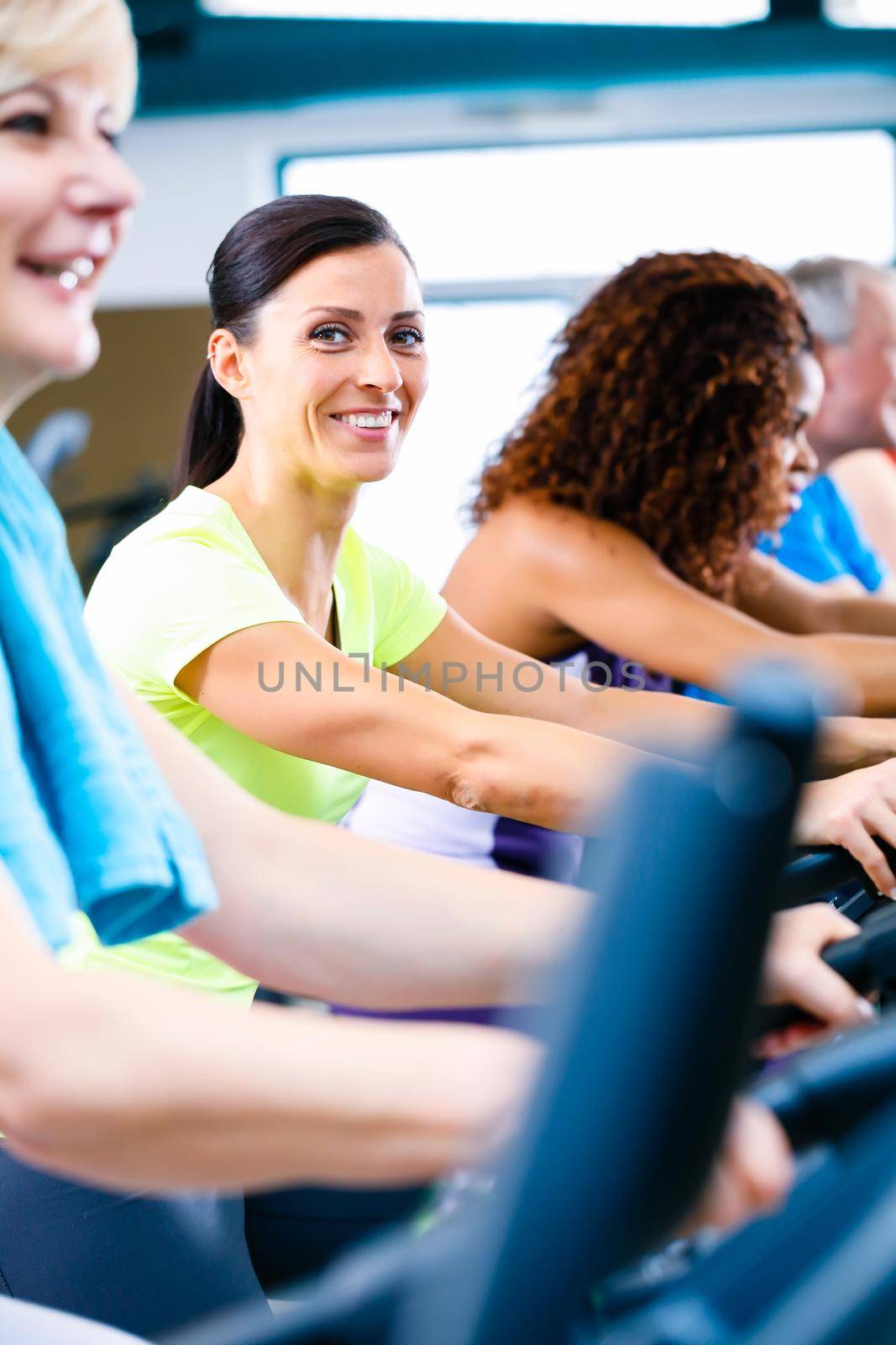 Men and women doing fitness spinning for sport, group of young and senior people