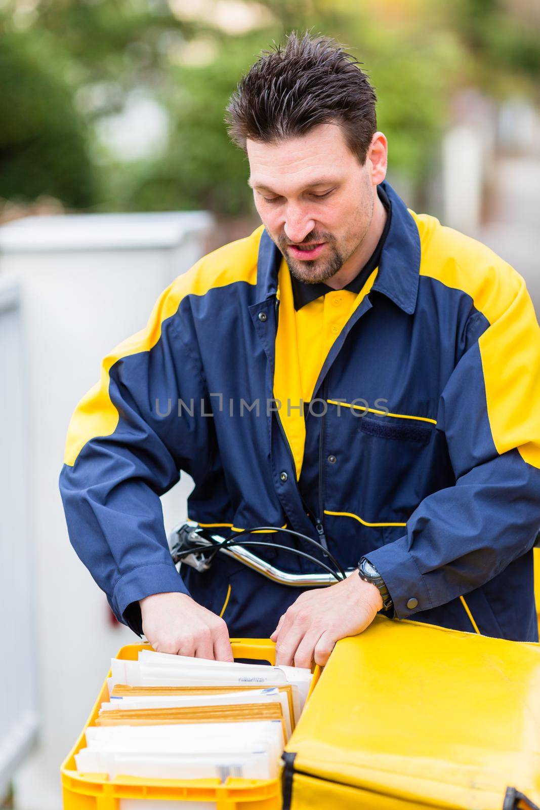 Postman delivering letters to mailbox of recipient