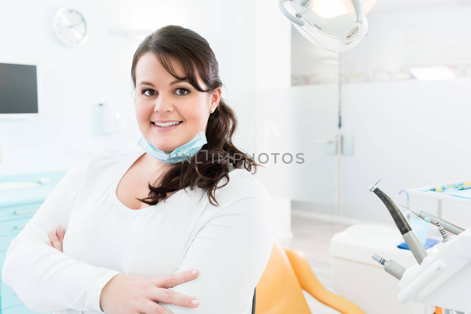 Dentist or nurse standing in dental surgery by Kzenon