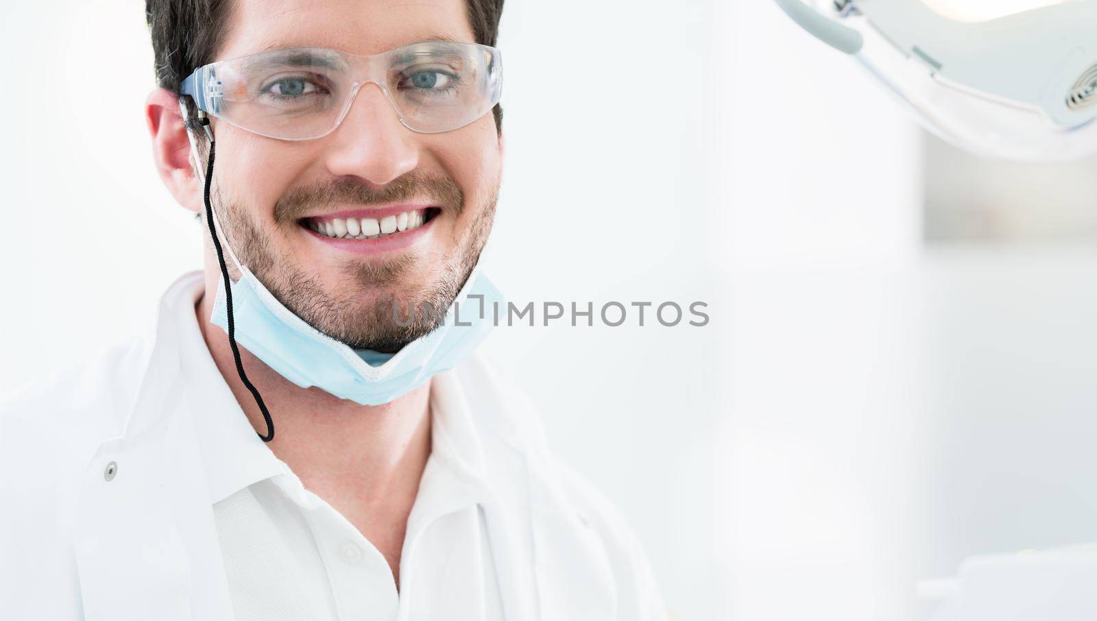 Dentist standing in dental surgery by Kzenon