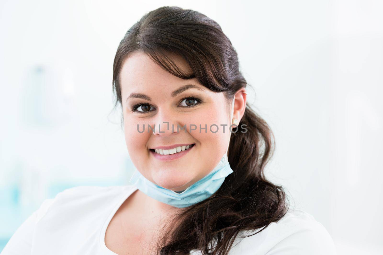 Dentist or nurse standing in dental surgery