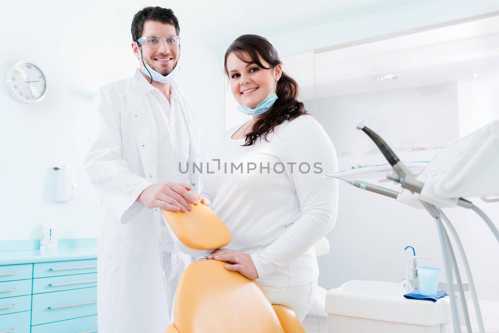 Dentist and nurse in their clinic as team by Kzenon