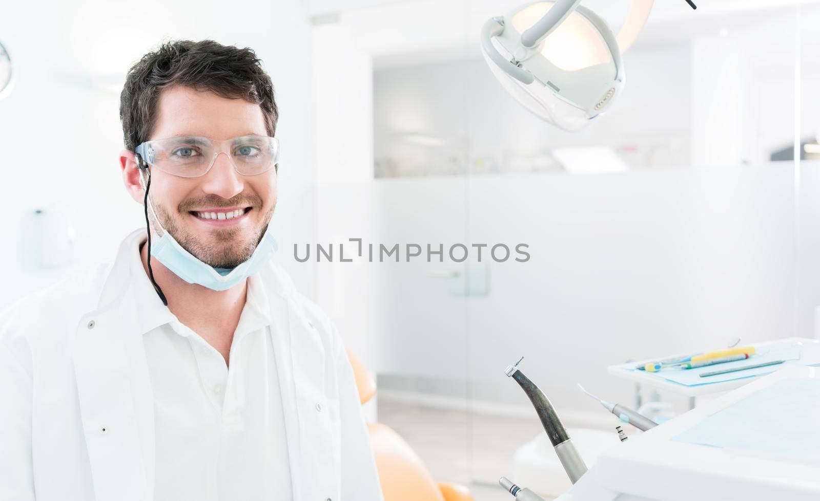 Dentist standing in dental surgery by Kzenon