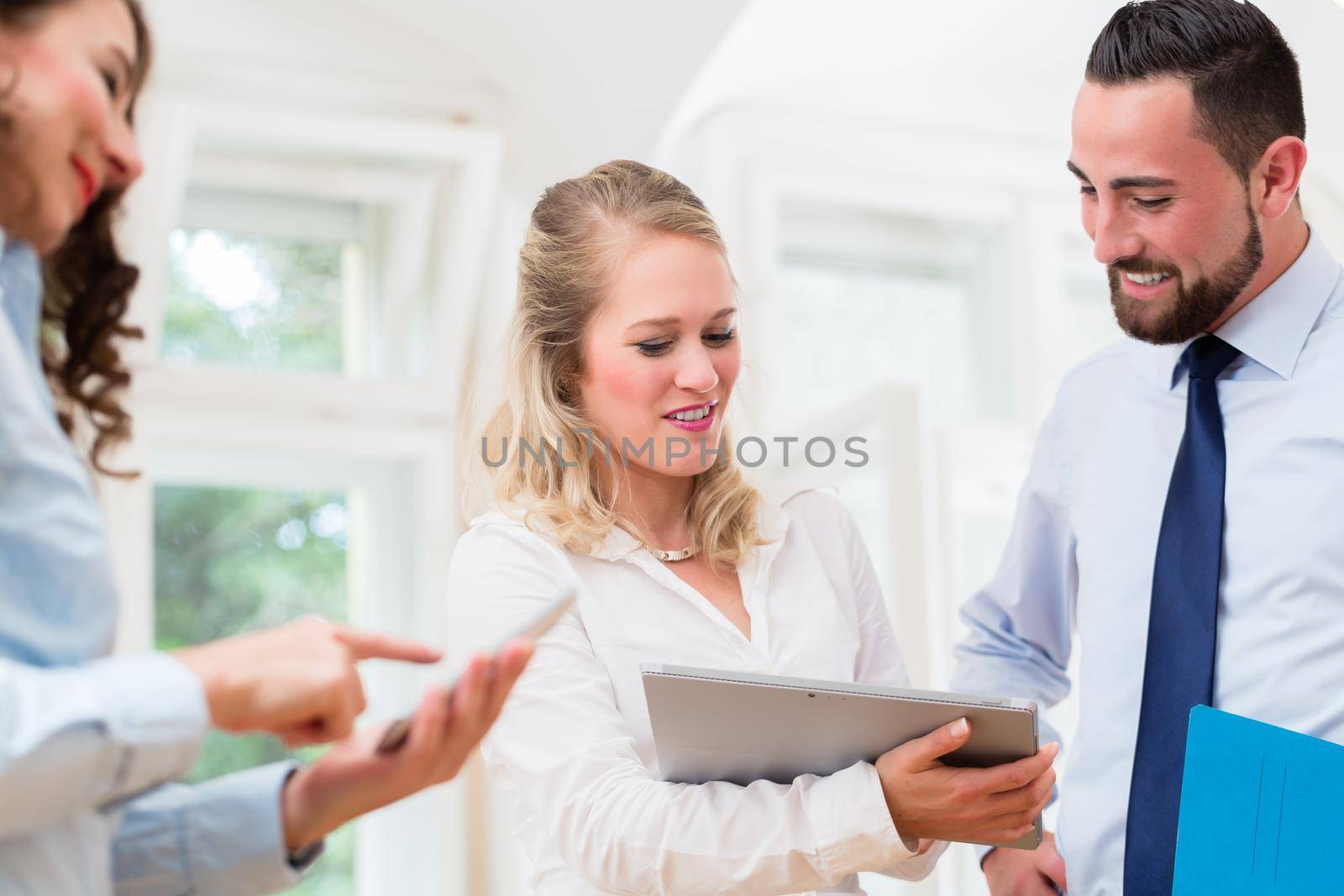 Business people in office having informal meeting and short presentation