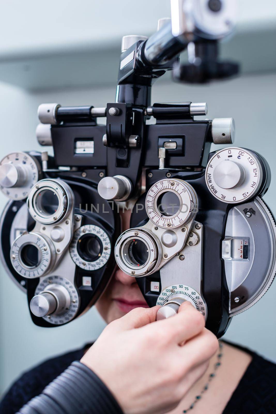 Woman at optometrist or doctor having eye sight testing