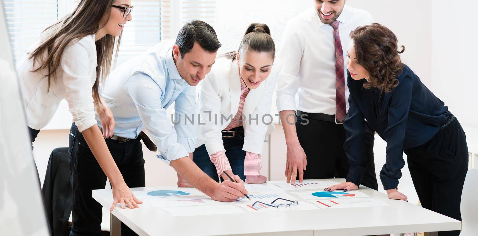 Financial consultants in bank analyzing data and discussing graphs