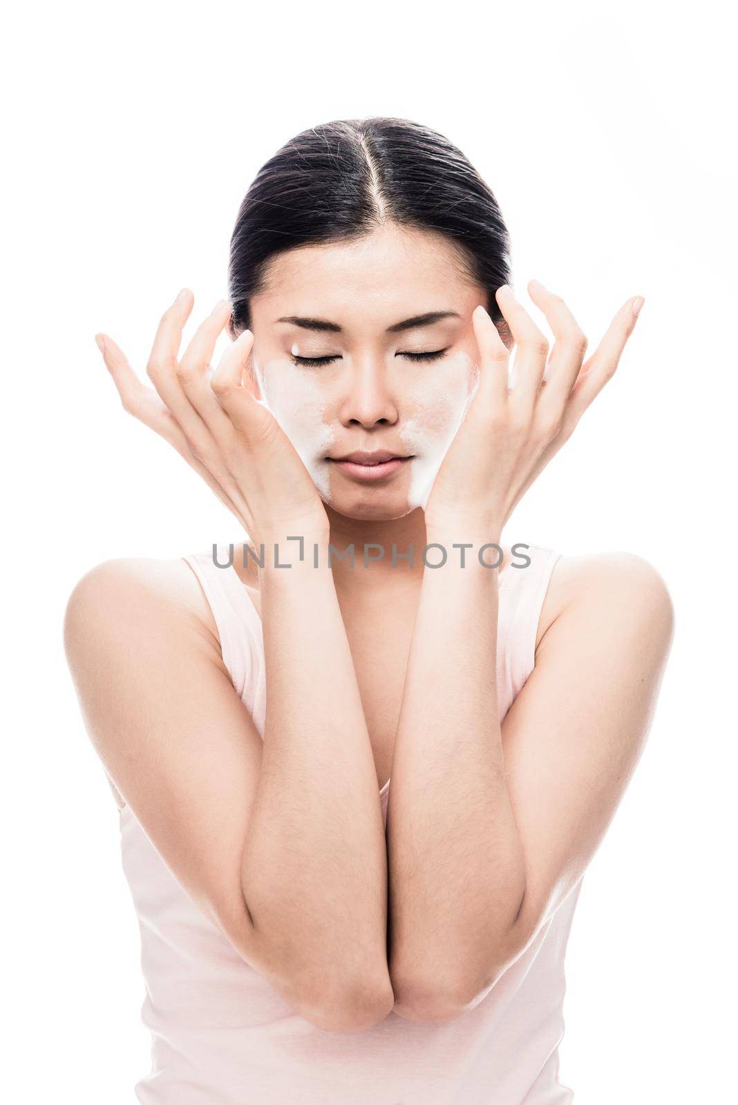 Beautiful young Asian woman applying facial moisturizer cream for sensitive skin care