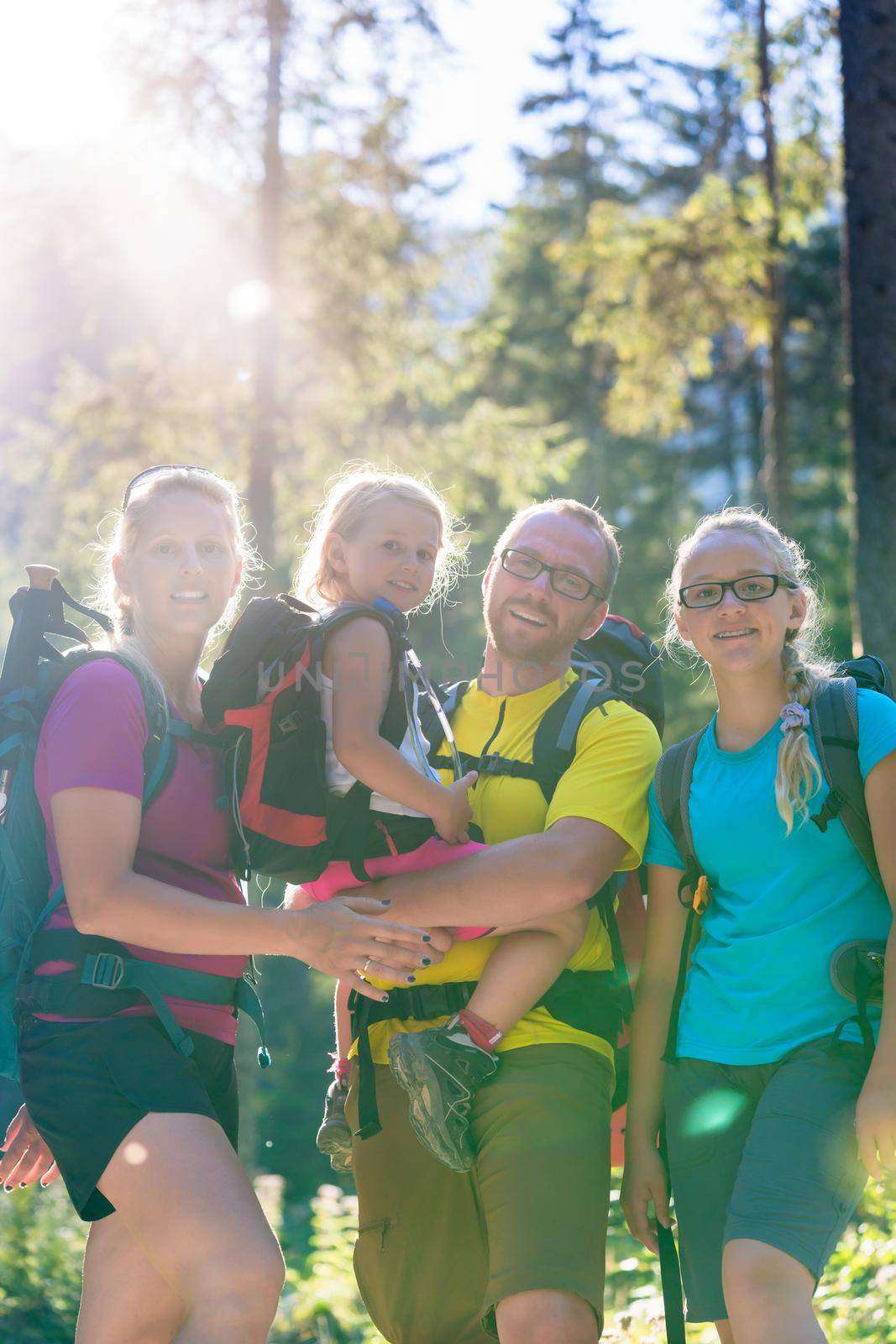 Family with two daughters on hike in the woods by Kzenon