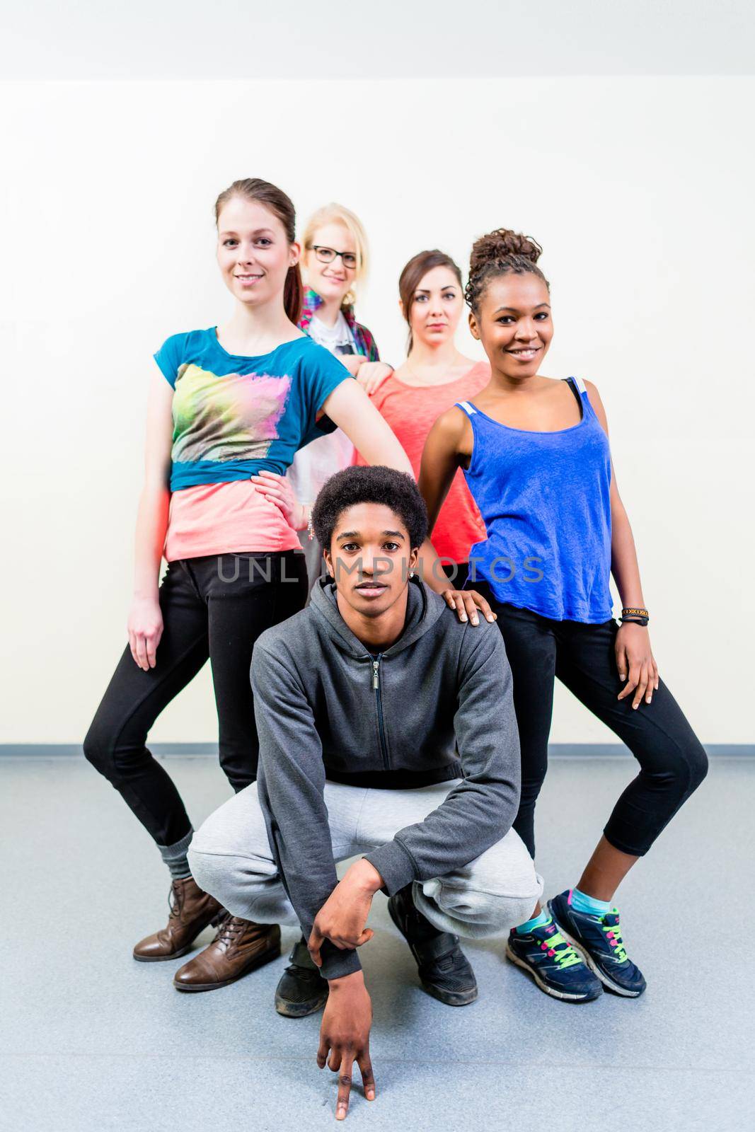 Young men and women in dance class posing