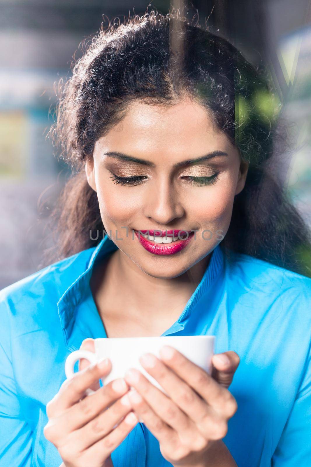 Indian woman with coffee mug and flirty expression